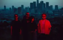 group photo, with city of L.A. in background